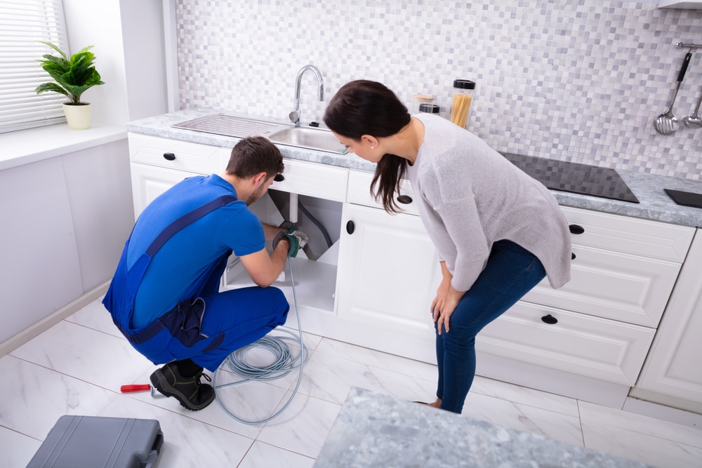 A professional plumber working on a residential plumbing system in Los Angeles
