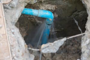 Leaking,Water,From,Blue,Pipe,From,Underground